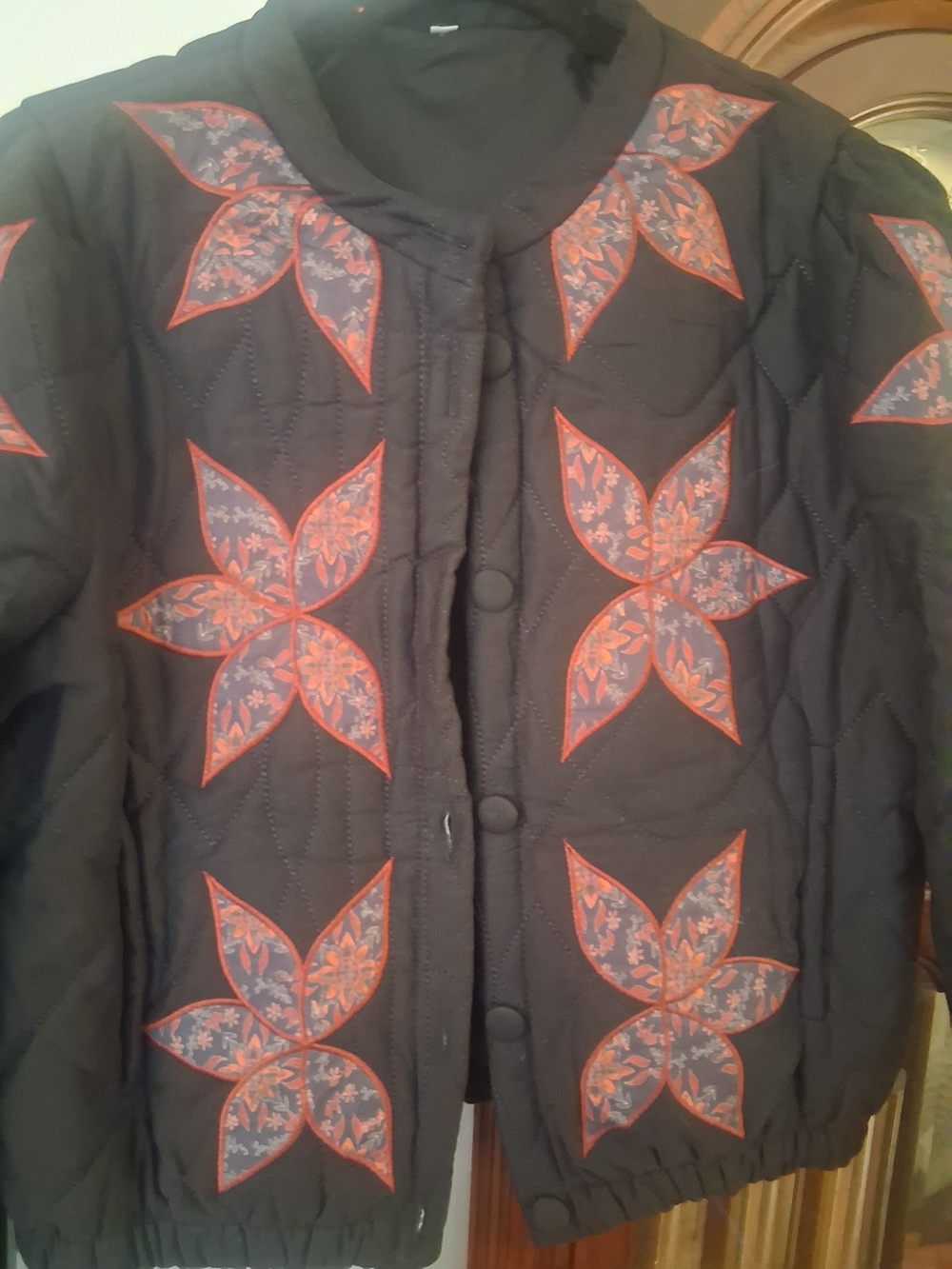 Black Quilted Bomber Jacket with Red Floral Star Appliqués